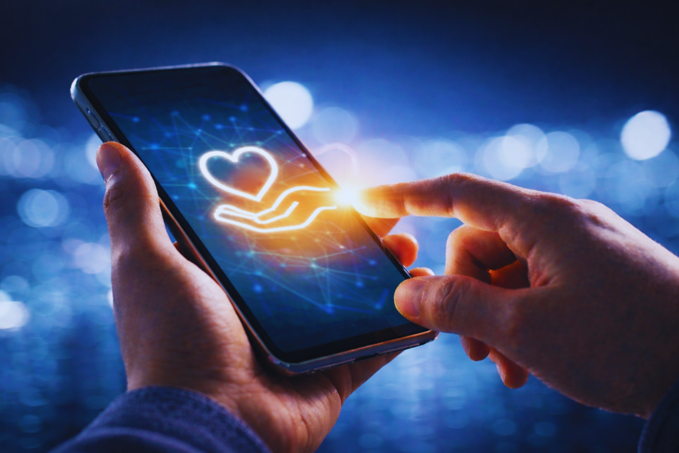 A person making a digital donation on a smartphone, symbolizing online charity and electronic giving through technology.