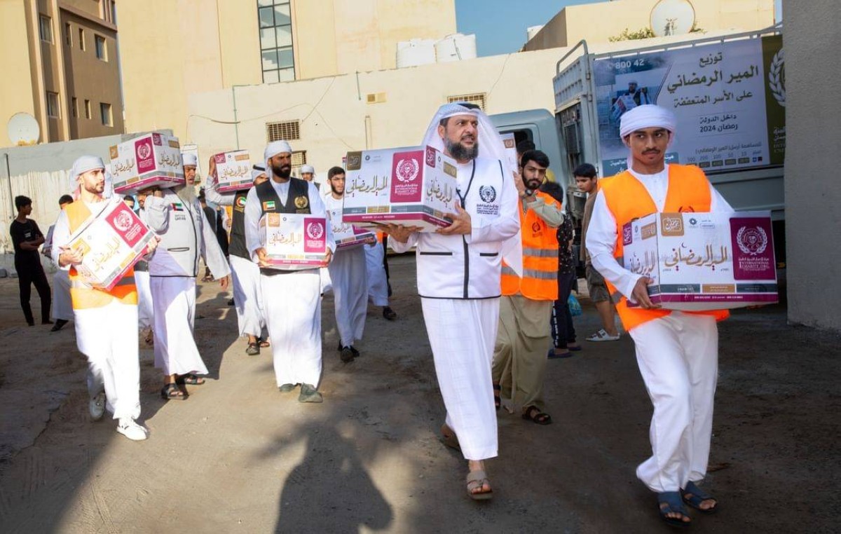 Volunteers from Global Charity Association distributing Ramadan food boxes to families in need as part of humanitarian initiatives in the UAE