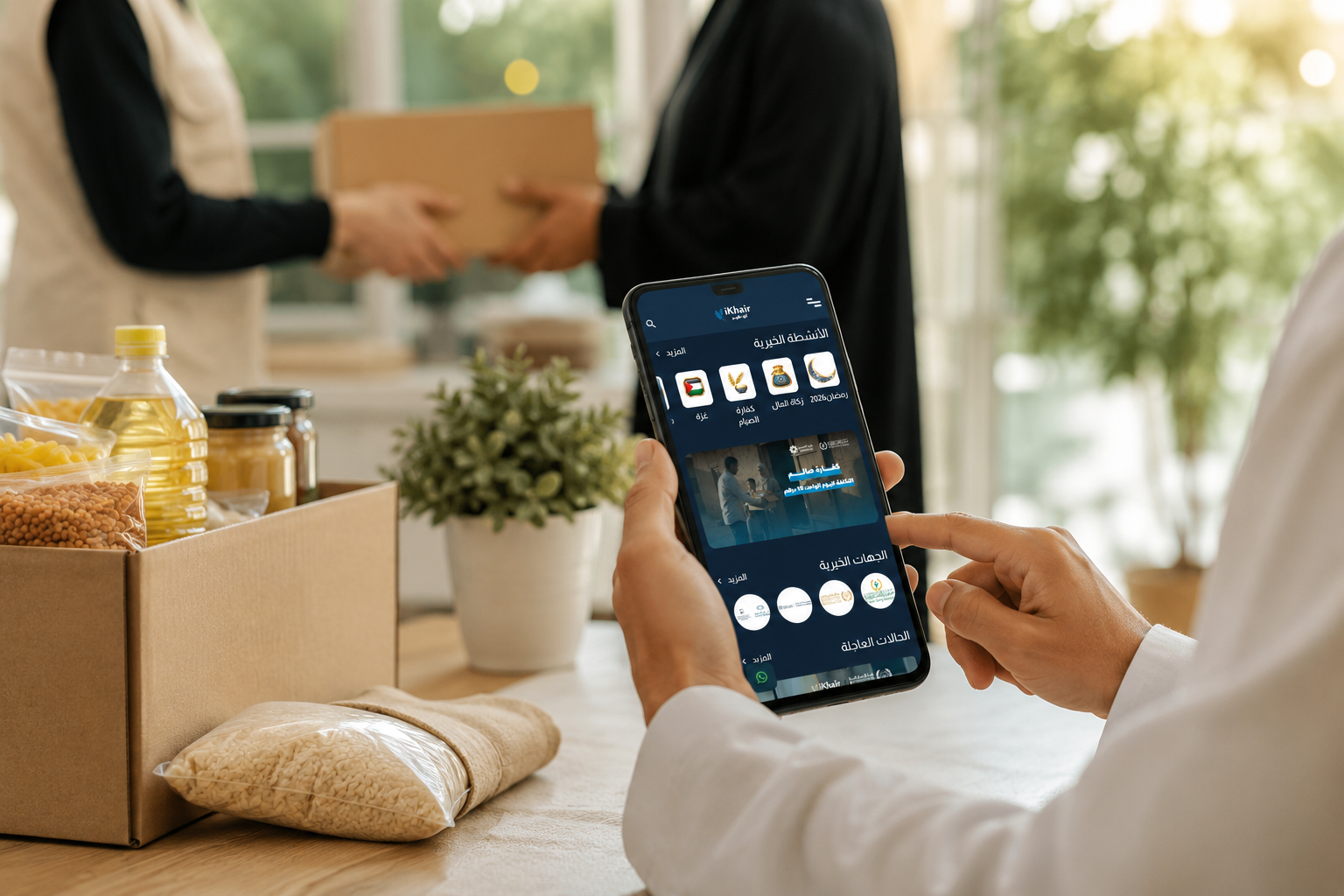 Person using the iKhair mobile app to make a charitable donation while food aid is being distributed to families in need.